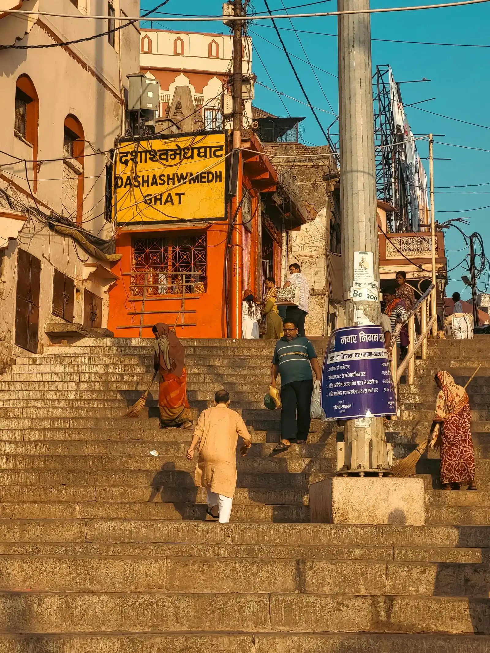 Pilgrims on the stone steps of Dashashwamedh Ghat Varanasi at dawn