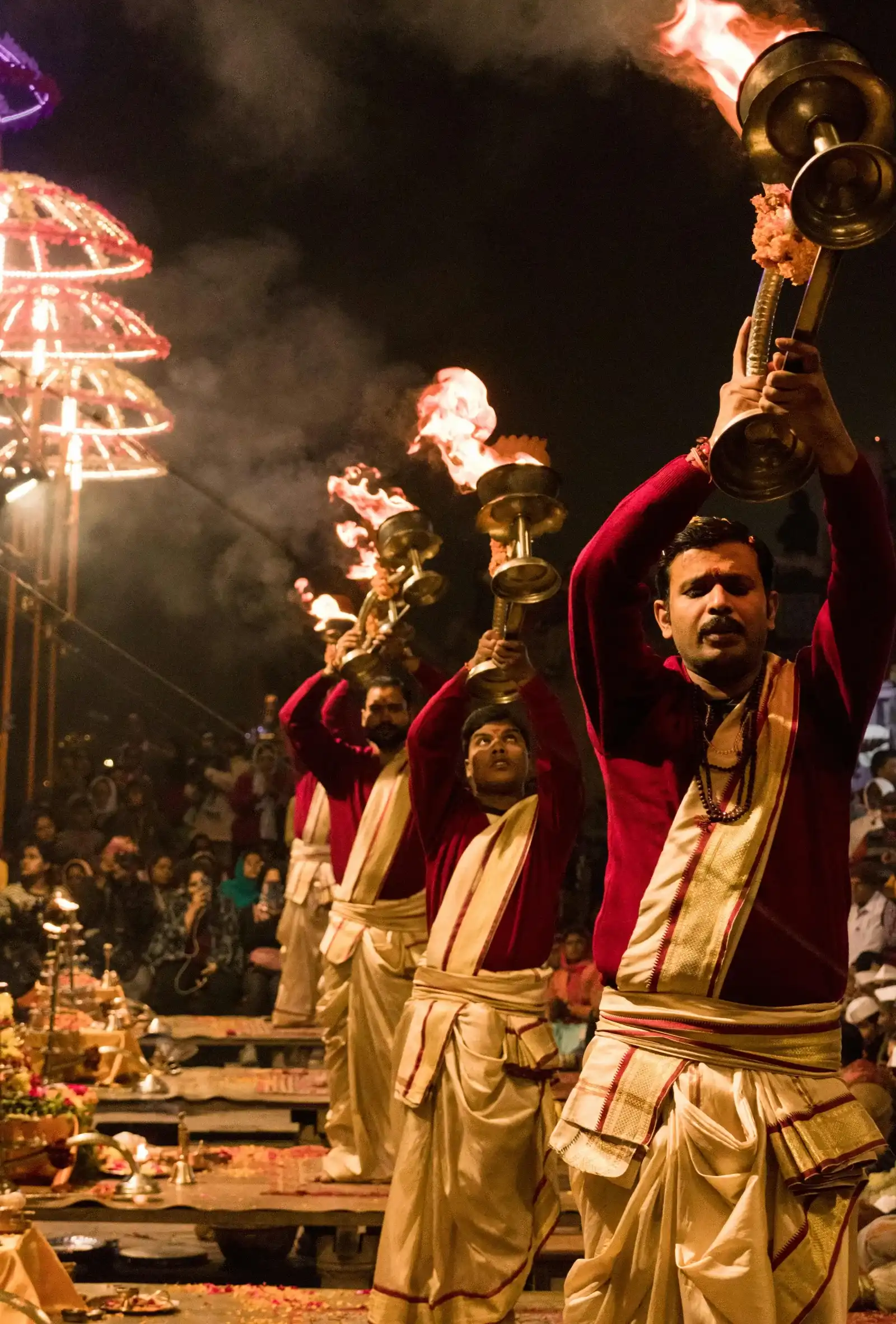 Priests performing Ganga Aarti with flaming lamps at Dashashwamedh Ghat Varanasi at night