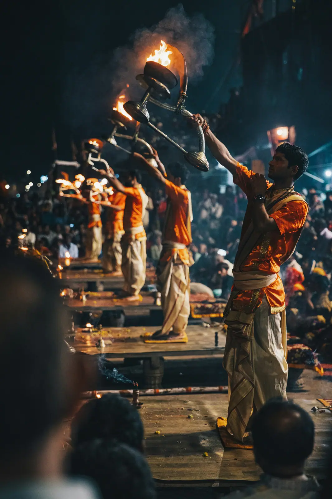 Priest performing Ganga Aarti flame ritual at Varanasi ghat at night