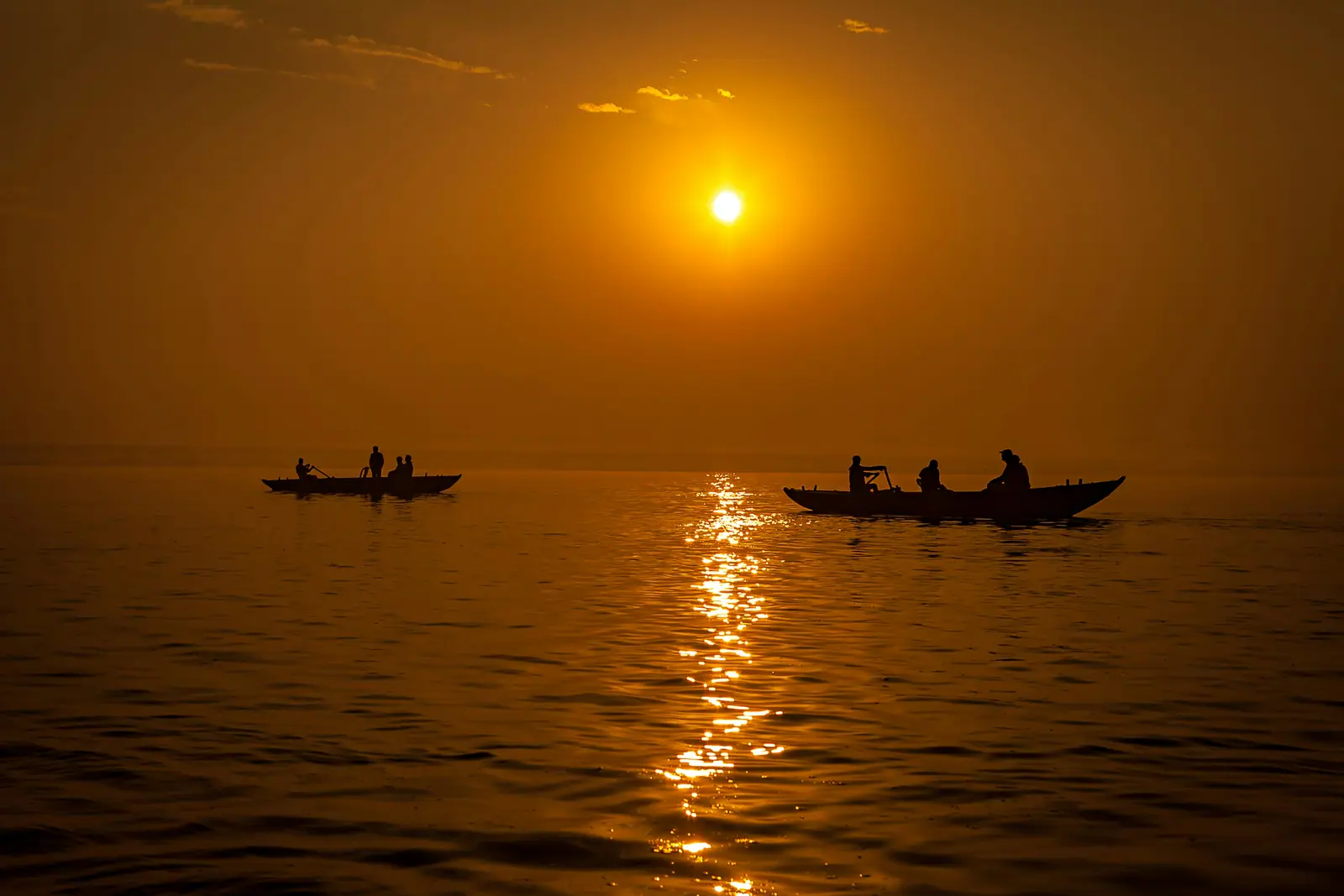 Silhouette of a boat on the Ganga at sunrise in Varanasi